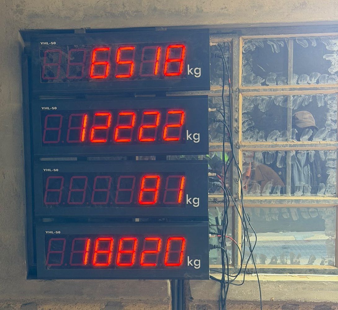 Four stacked YHL-50 remote display units in a Kenyan weighbridge office, each showing one deck weight in kilograms