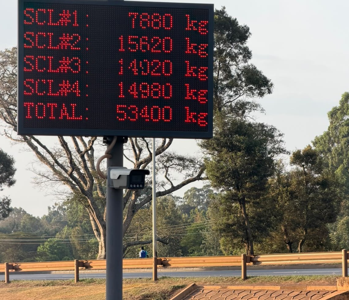 Roadside LED weighbridge scoreboard in Kenya showing four scale weights and a 53,400 kg total, with an ANPR camera mounted below it
